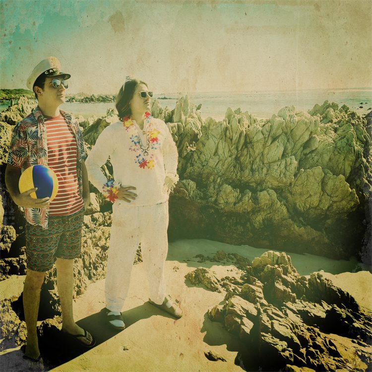Sines of Ballet — two artists standing on rocky shoreline in retro vintage tones
